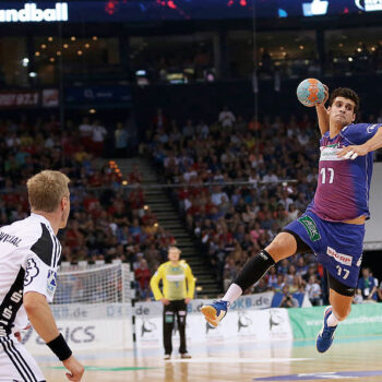 Ein Handballspieler bei Sprungwurf, kurz bevor er den Ball wirft.